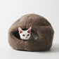 Cat peeking out from a brown cat bed on a white background  | Natural, non‑toxic pet nest for cats and small dogs | Cozy, handmade pet furniture


