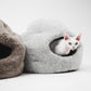 Two cat beds, one gray and one brown, with a white cat peeking out on a white background.