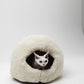 Cat peeking out from a white cat bed on a light gray background | Natural, non‑toxic pet nest for cats and small dogs | Cozy, handmade pet furniture, natural wool and sheepskin

