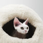 Cat peeking out from a white woolen pet bed against a light gray background | Natural, non‑toxic pet nest for cats and small dogs | Cozy, handmade pet furniture, natural wool and sheepskin

