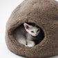 Cat lying inside a brown pet bed on a white background  | Natural, non‑toxic pet nest for cats and small dogs | Cozy, handmade pet furniture

