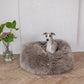 In the room, a dog is comfortably nestled on a fluffy Oval Natural Sheepskin Pet Bed made by Mellow Pet Store.